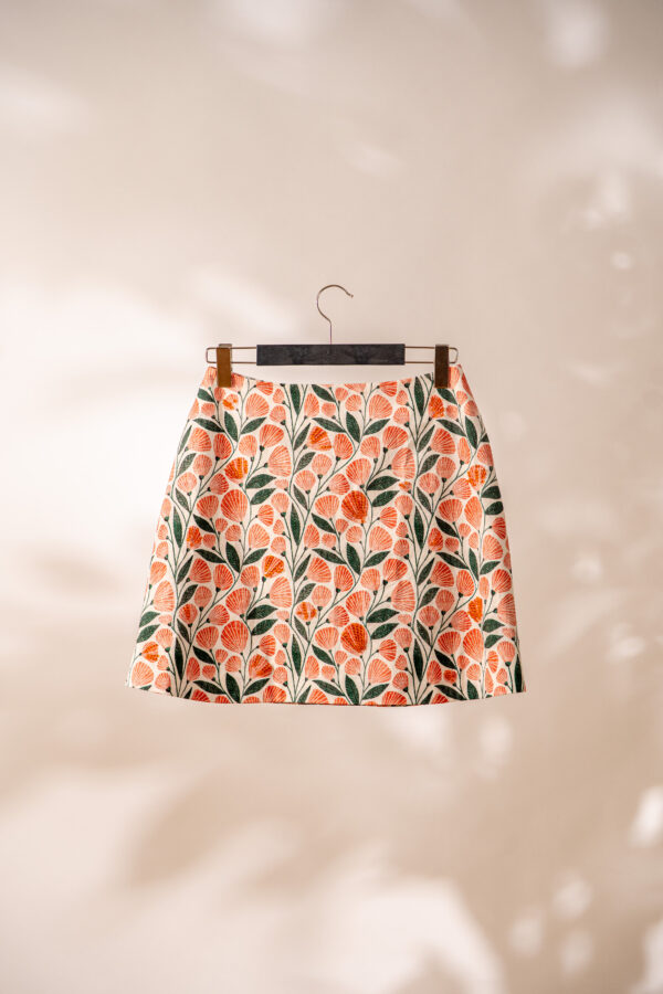 Feminine skirt with orange beads and patterned fabric